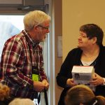 Terry Buttler, Past Chair, awards a Kobo reader as prize in draw
